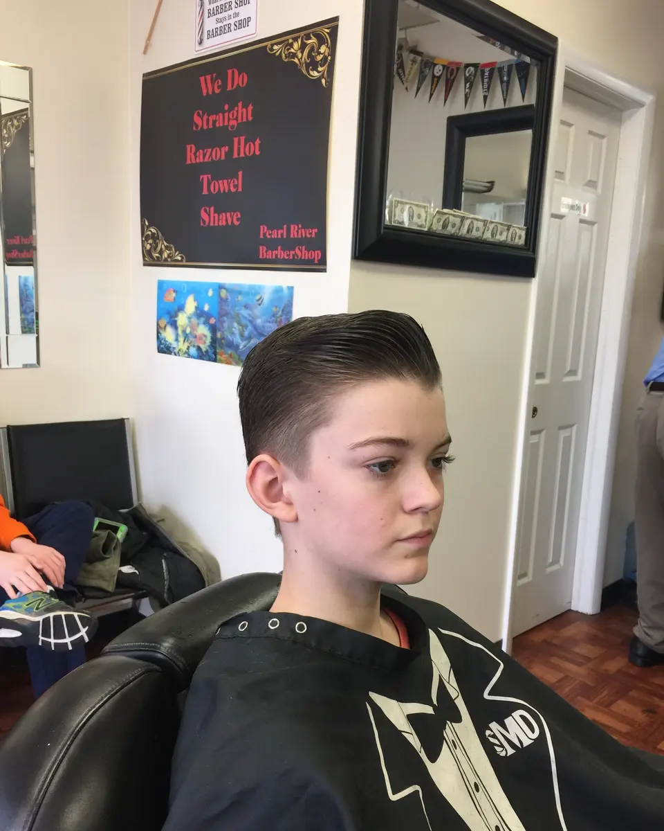 A kid’s side-part cut with faded sides at Pearl River Barber Shop