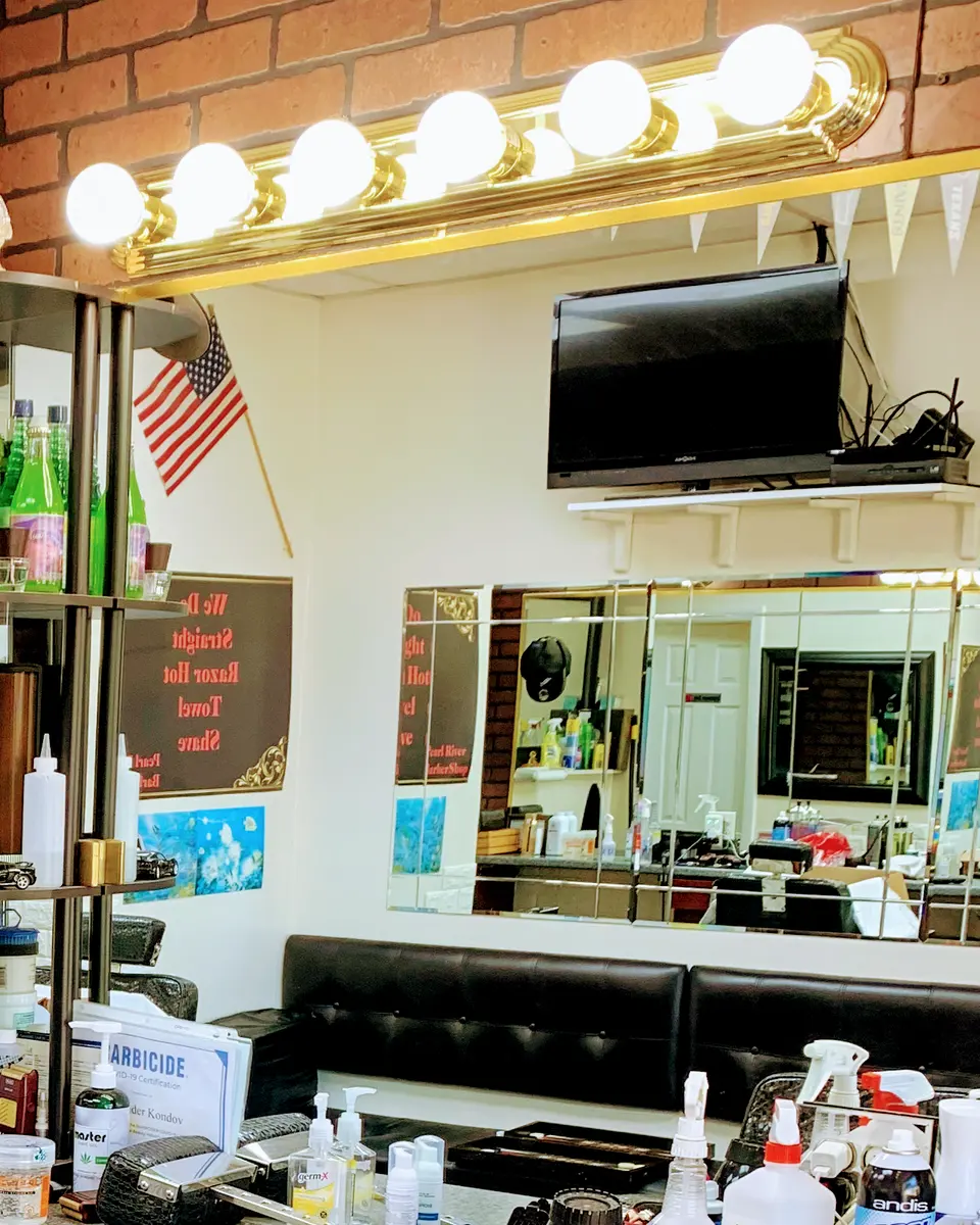Inside Pearl River Barber Shop: mirrors, lights and barber stations